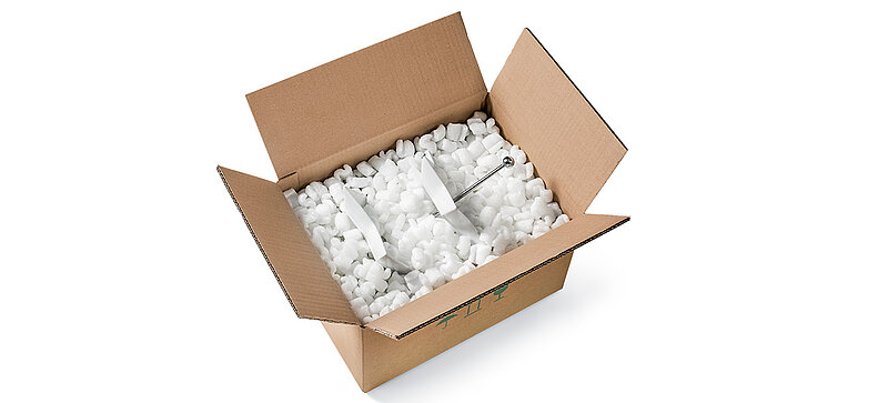 A cardboard box containing an étagère and S-shaped bioplastic packaging chips