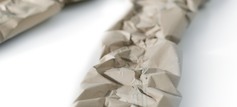 A brown paper cushioning strip made from grass paper