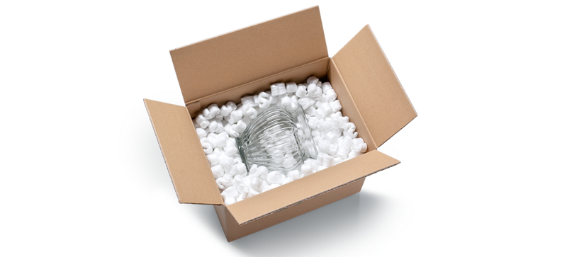 A cardboard box containing a glass vase and S-shaped white packaging chips