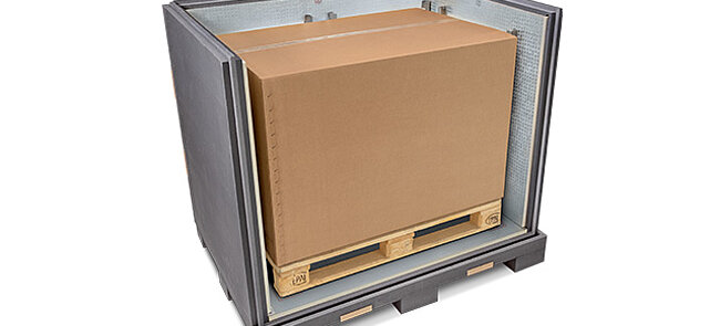 A grey insulated container with an inner carton and cooling elements on a pallet 