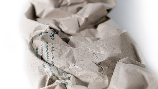 A brown paper cushioning strip made from recycled paper