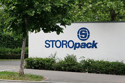 A white wall with blue Storopack logo