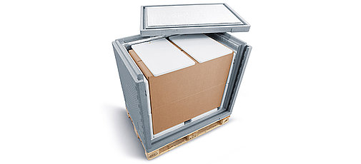 A gray insulated container with an inner carton and cooling elements on a pallet
