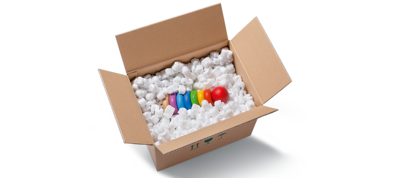 A cardboard box containing a children’s toy and S-shaped white packaging chips
