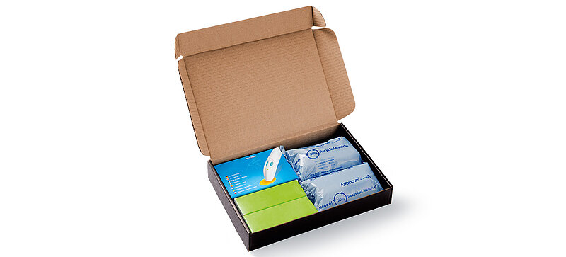 Open cardboard box with protective air cushions