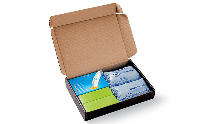 Open cardboard box with protective air cushions