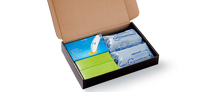Open cardboard box with protective air cushions