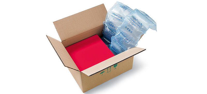 A cardboard box containing a red box and 100% Recycled air cushions